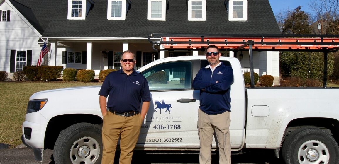 Chris and Rob, two roofing experts from Saint Louis Residential Roofing, pose in front of a home and truck.